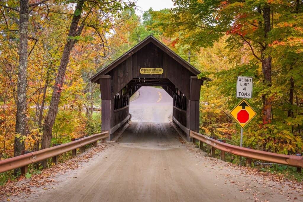 Things to do in Stowe Vermont. Picture of a  covered bridge in fall, called Emily's Bridge.
