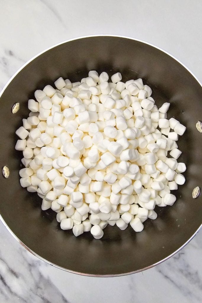 A large saucepan filled with mini marshmallows ready to be melted for making rice krispie treats.