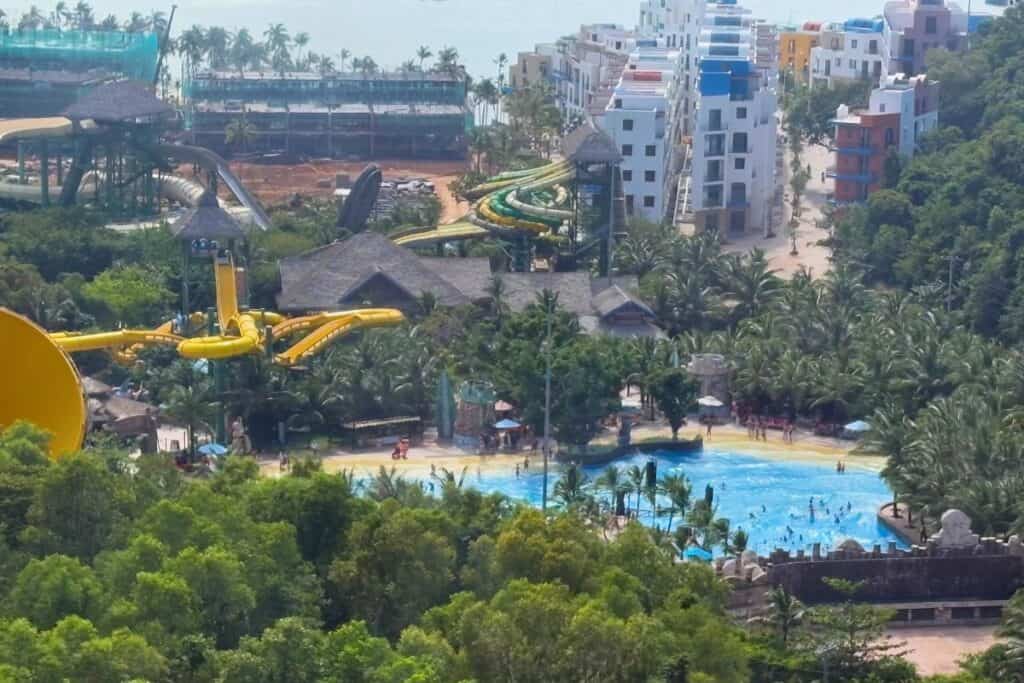 View of Aquatopia waterpark from above, with waterslides and beach area.