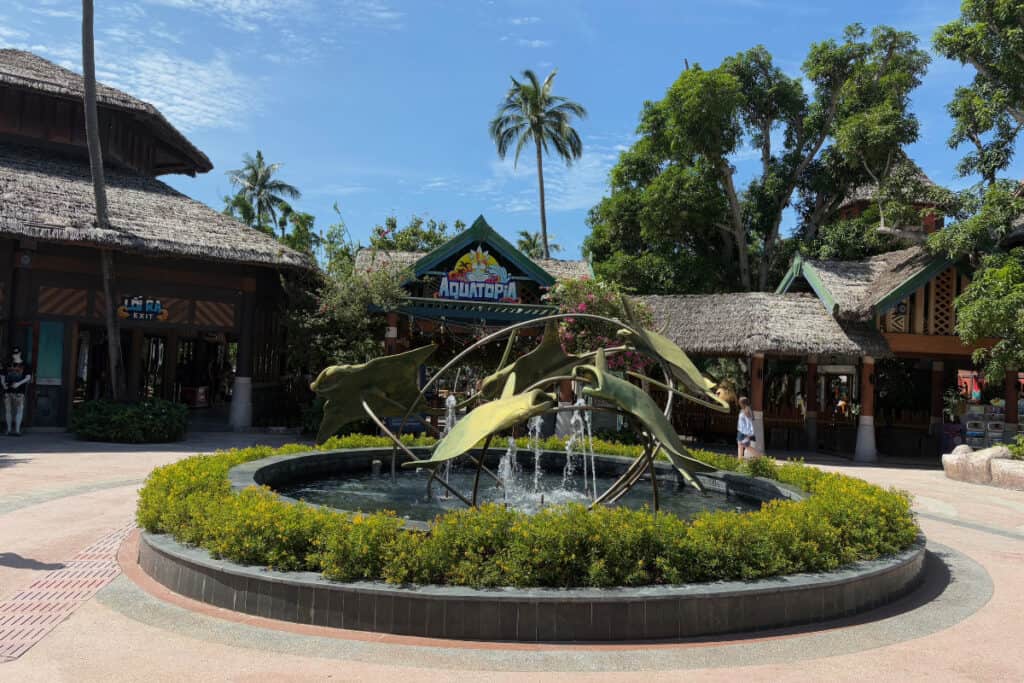 A fountain with meatl jumping fish, in front of the entrance to Aquatopia Water Park in VIetnam