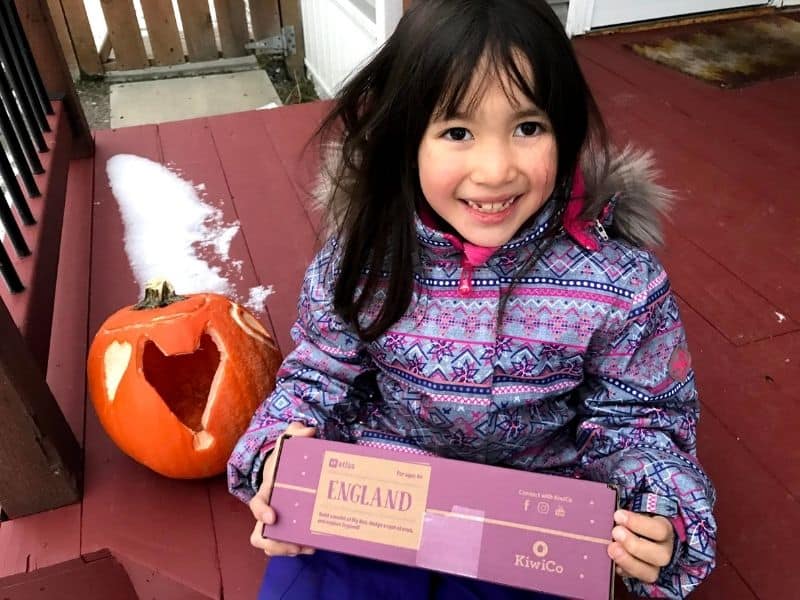 Kids camping gift. Girl smiling holding atlas craft crate.