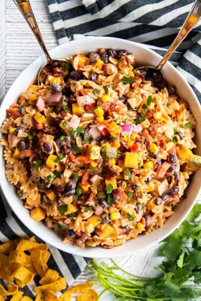 Bow tie Pasta BBQ ranch salad with bacon, chicken, cheddar cheese, bell peppers, black beans and corn. 