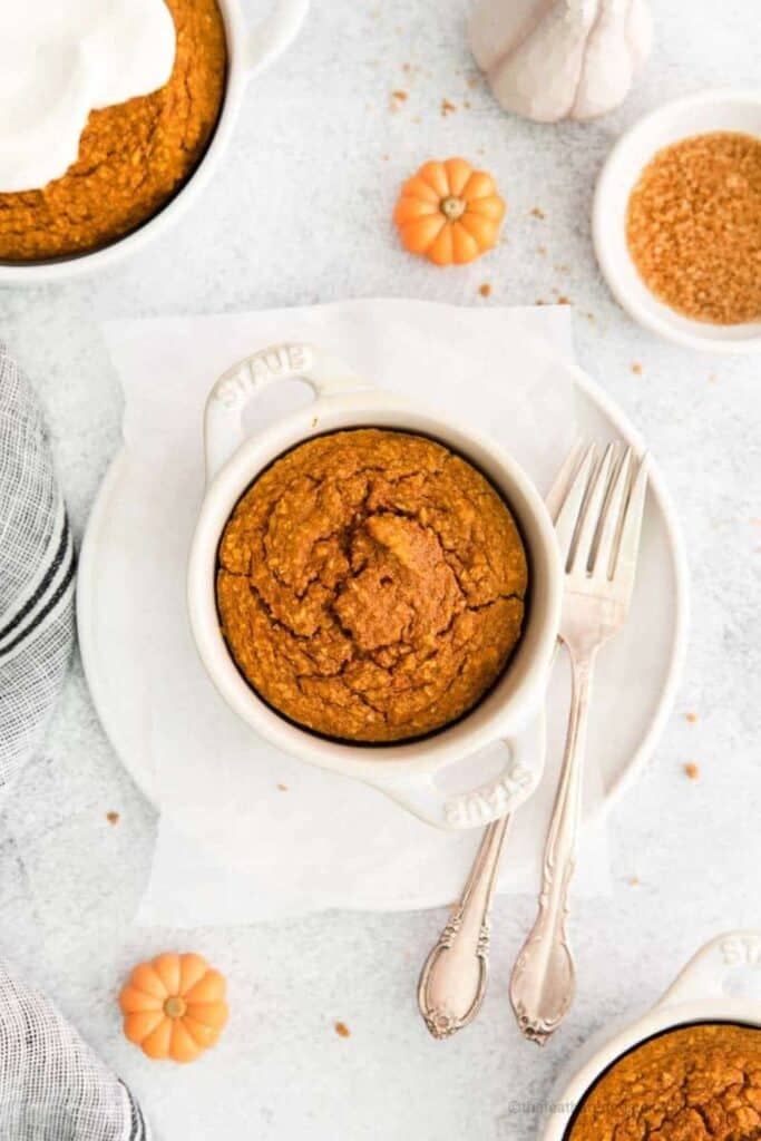 Medium sized ramekin filled with baked pumpkin oatmeal. 