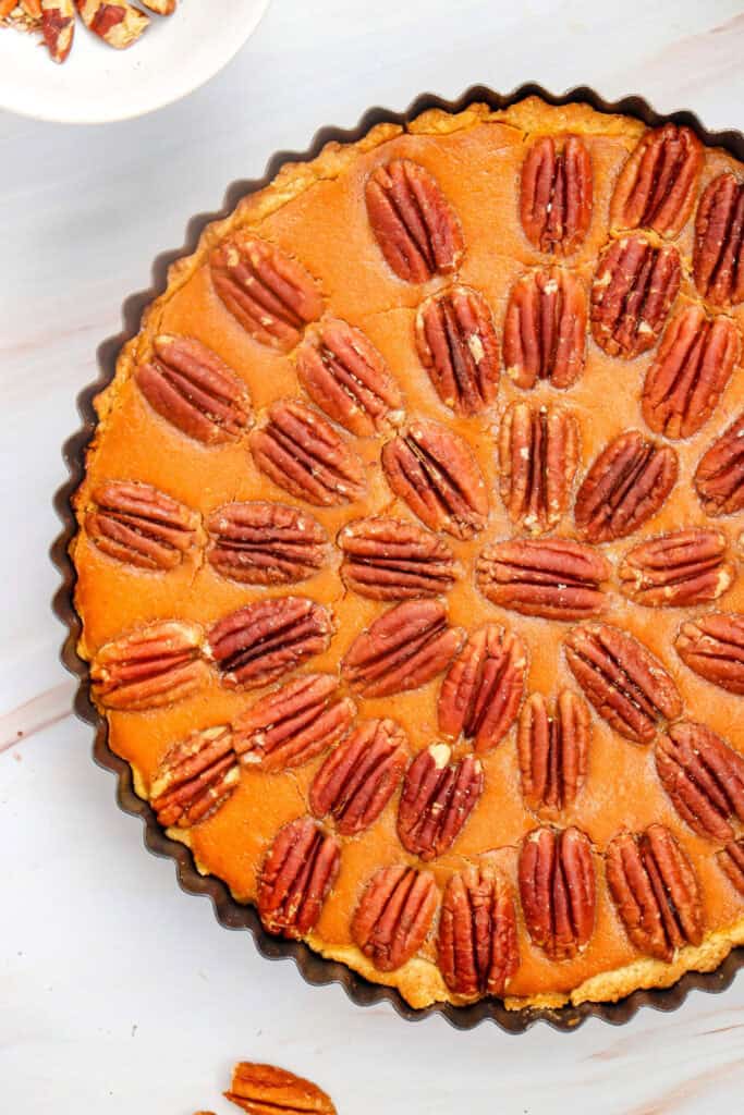 Close up of the baked Pumpkin Cheesecake Pecan Pie