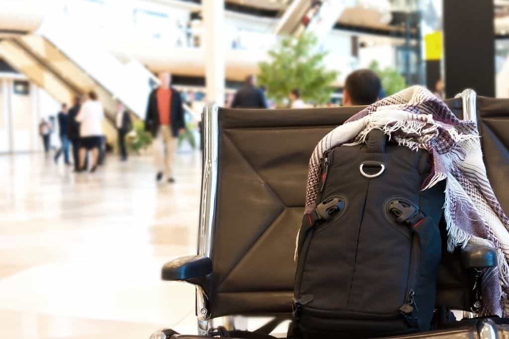 Picture shows a anti theft Backpack on chair at airport