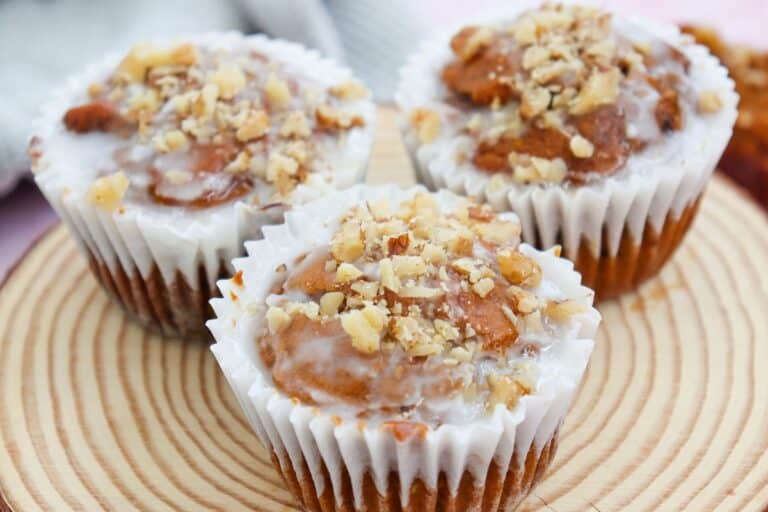 3 breakfast pumpkin muffinson a wooden plate.