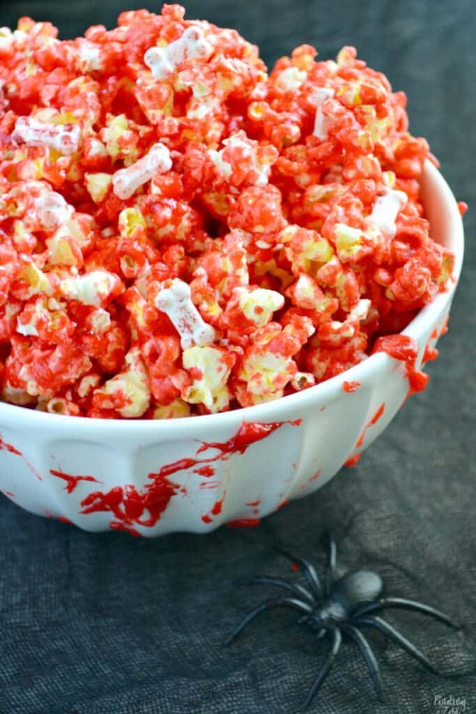 Bowl of red colored "bloody" popcorn with bones for Halloween. 