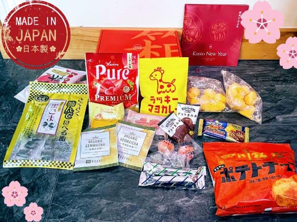 Many Japanese snacks laid out on tile from Bokksu Subscription Box from Japan