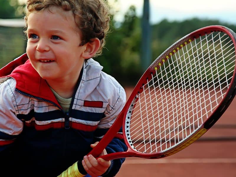 Boy holding a tennis racket.