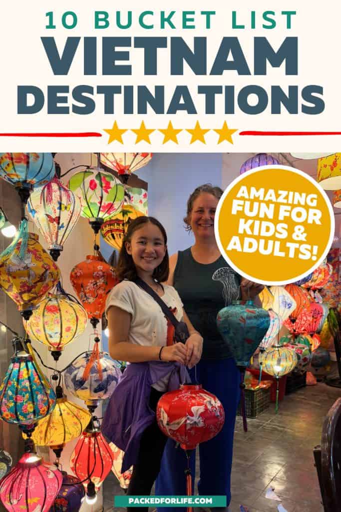 Mother and daughter smiling while holding colorful lanterns at a night market, representing a fun Vietnam bucket list with kids.