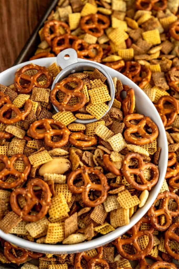 Bowl of Cajun Chex Snack mix for road trips with pretzels, mixed nuts and Chex Cereal. 