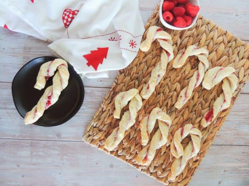 9 Candy Cane raspberry puff pastries on a wicker plate. 