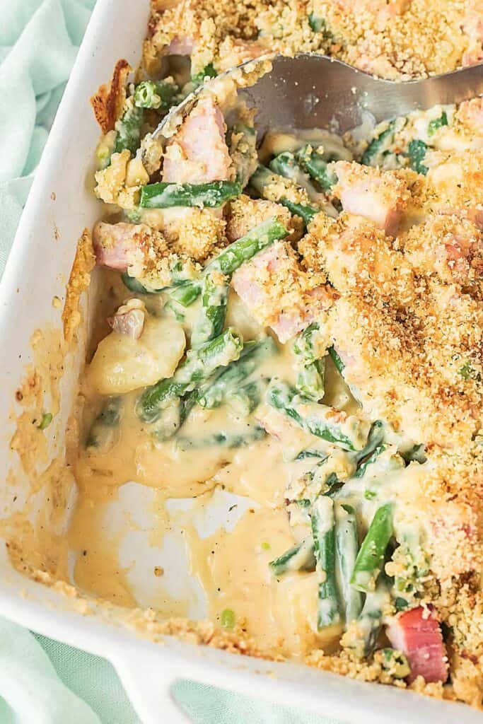 Creamy cheesy ham, potato and green bean casserole topped with golden breadcrumbs, a hearty comfort food dish for cozy fall dinners.