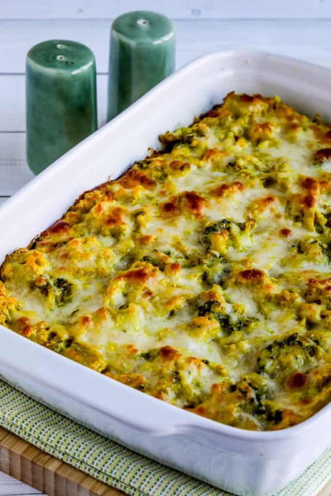 Rectangle baking dish with curry chicken broccoli & cauliflower rice casserole with melted cheese on top. 