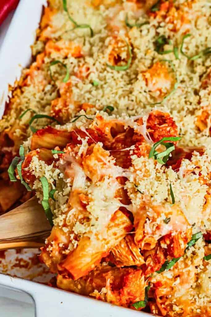 Chicken Parmesan casserole with rigatoni pasta, chunks of chicken, tomato sauce, melted cheese, golden breadcrumbs and fresh basil, an easy kid friendly fall dinner.