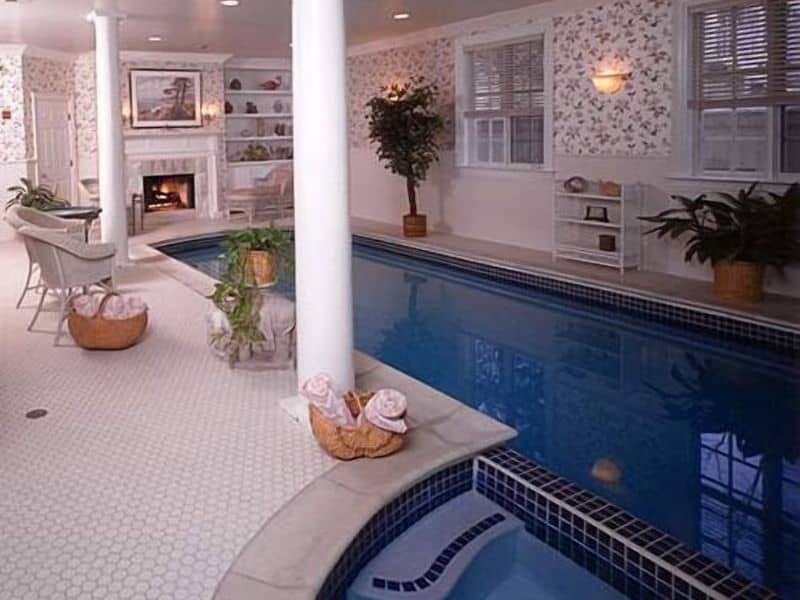 Small Indoor pool with couches & fireplace