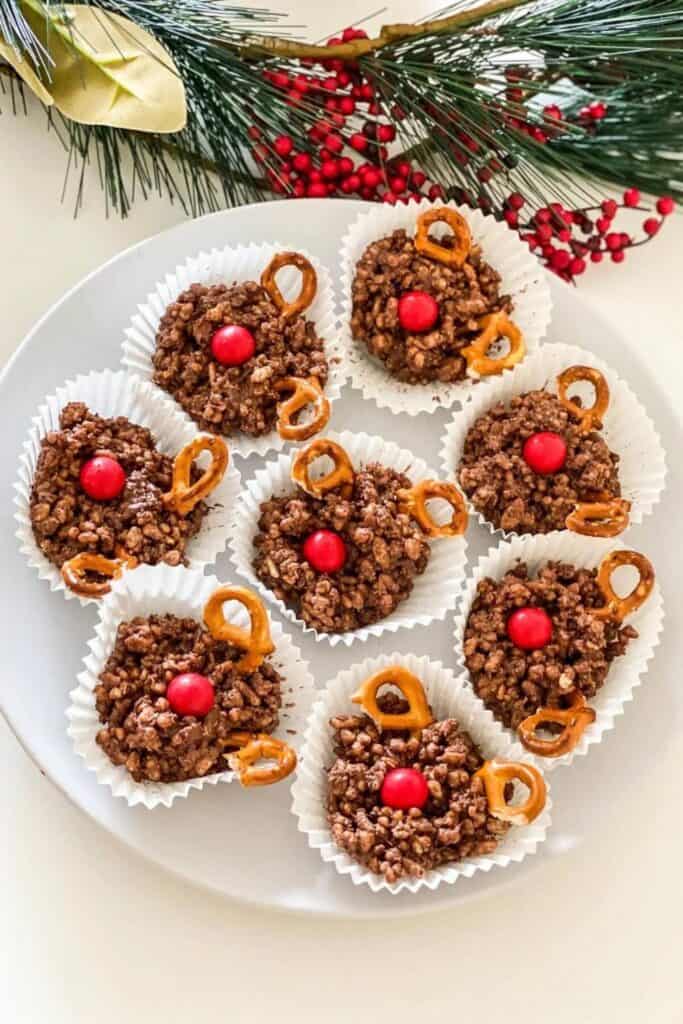 plate full of chocolate reindeer crackles with re M&M's for noses and pretzels for horns. 