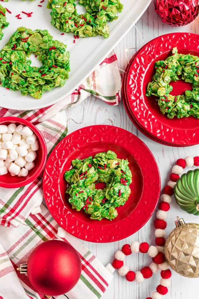 Holiday plates with Christmas wreathe cookies made out of cornflakes. 