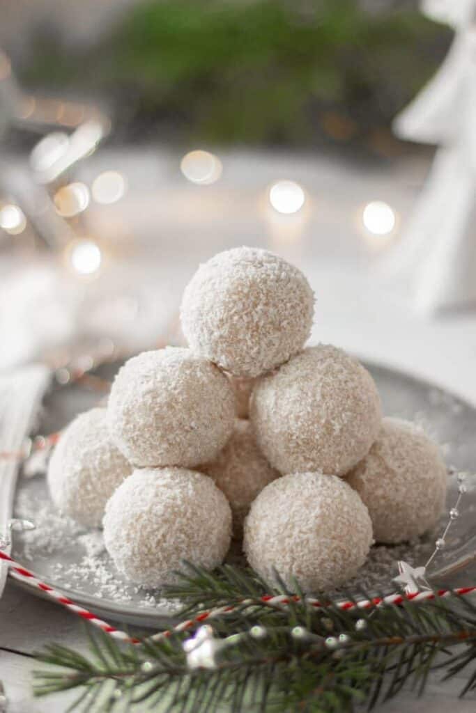 Plate piled high with no bake coconut snowballs. 