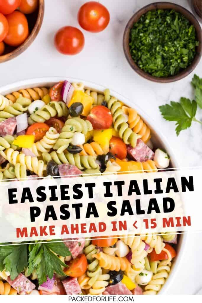 Easiest Italian Pasta Salad make ahead. Bowl of Italian Pasta Salad with salami, mozarella balls, olives and peppers. 