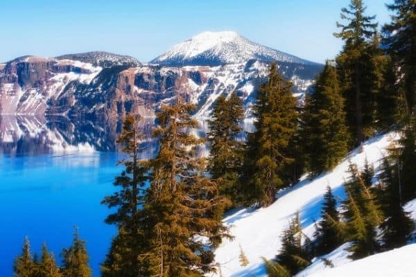 Snowy mountain reflected in Crater Lake, National Park, USA