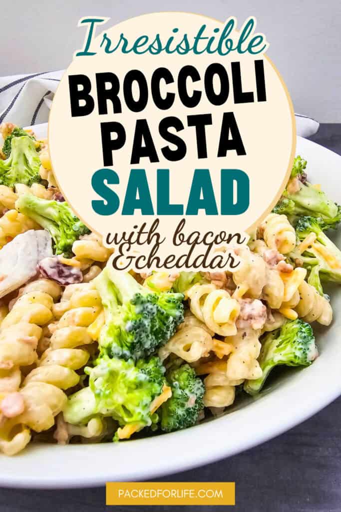 Bowl of creamy Broccoli pasta sslad with Rotini Pasta, fresh broccoli, bacon bits, dried cranberries and cheddar cheese.