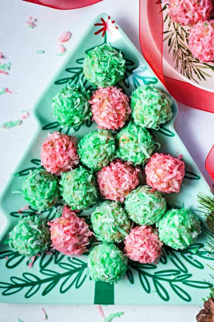 A Christmas Tree Shaped serving dish filled with Crispy Cocounut balss in red and green.