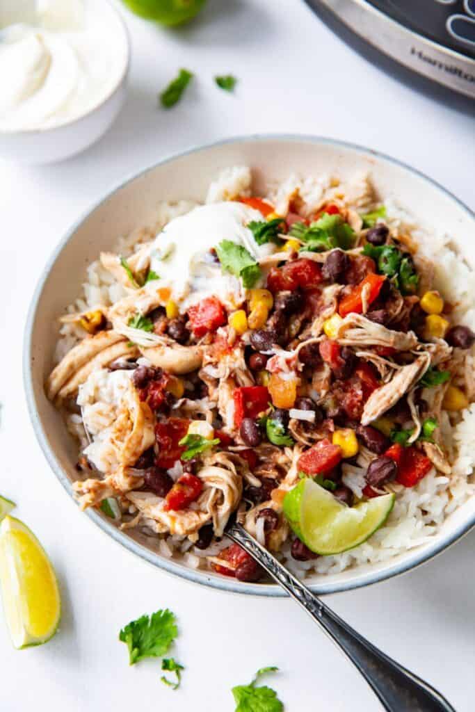 Rice bowl with southwest chicken with black beans, corn, tomatoes and cilantro. 