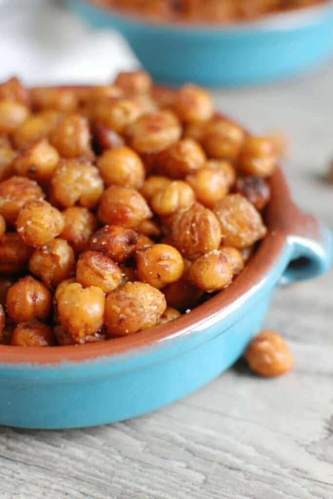 Close up of a ceramic low bowl with crunchy roasted chickpeas. 