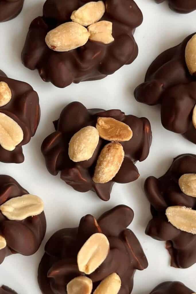 Rows of dark chocolate peanut clusters. 