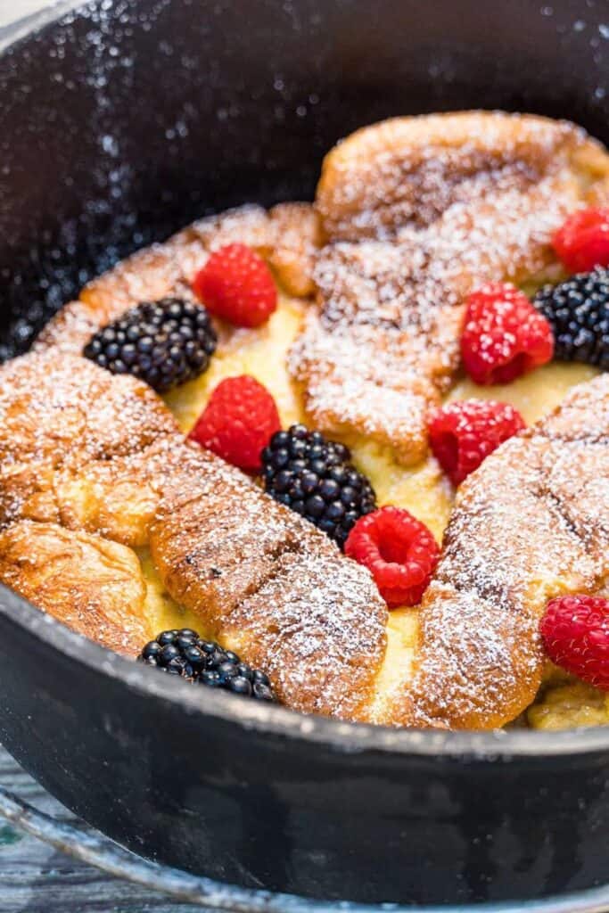 Berries over Dutch Baby Pancake in a cast iron Dutch Oven pan.