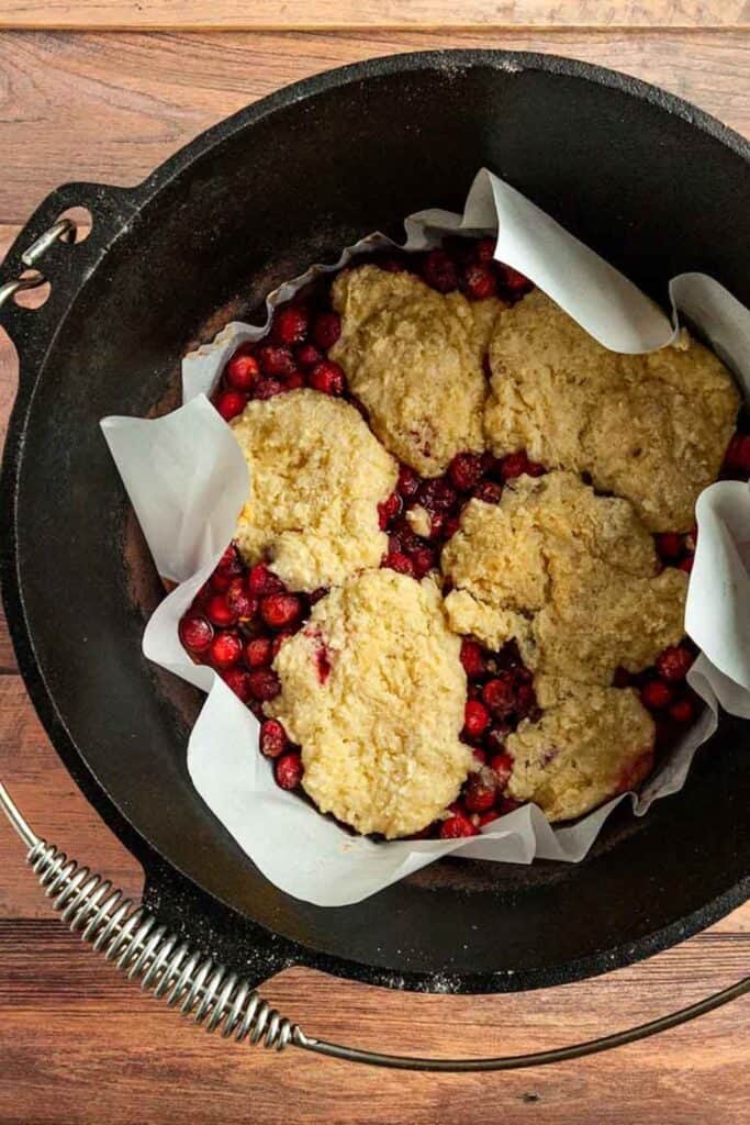 Cast iron dutch oven filled with Cranberry Cobbler