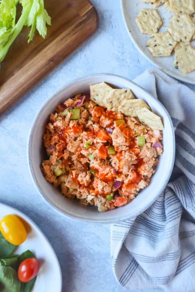 Bowl of tuna salad drizzled with buffalo sauce. 