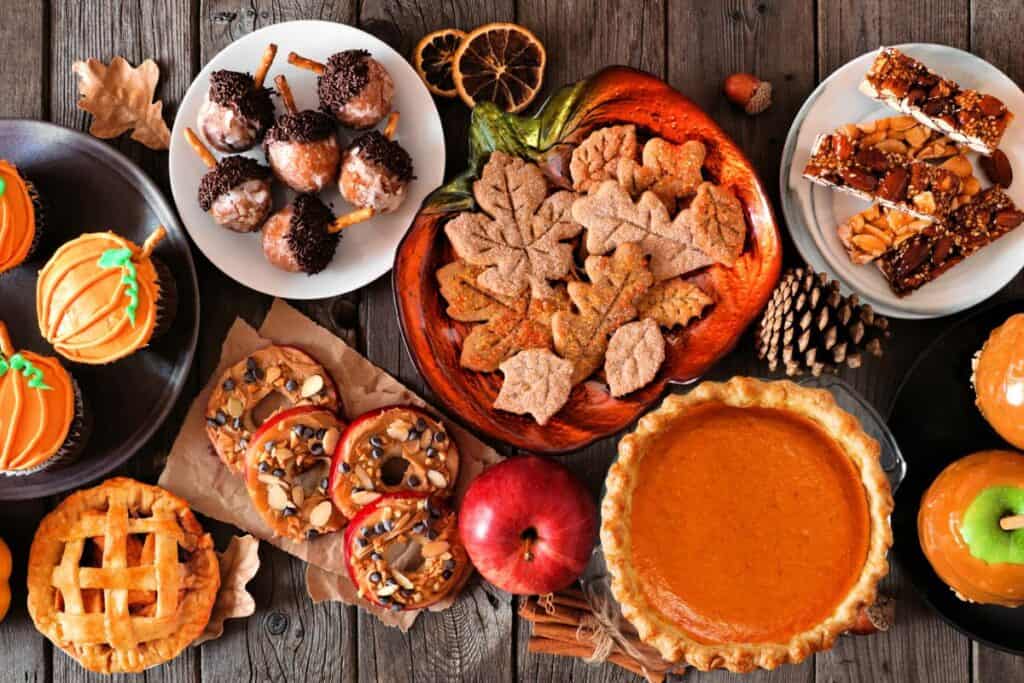 Wooden table top filled with Autumn desserts.