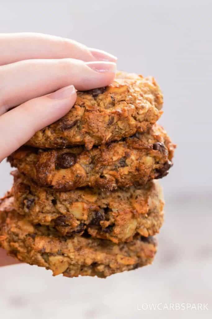 hand holdinding 4 keto breakfast cookies with chocolate chips