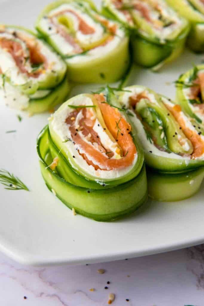 Lines of cucumber, smoked salmon rolls seasoned with everything bagel salt. 