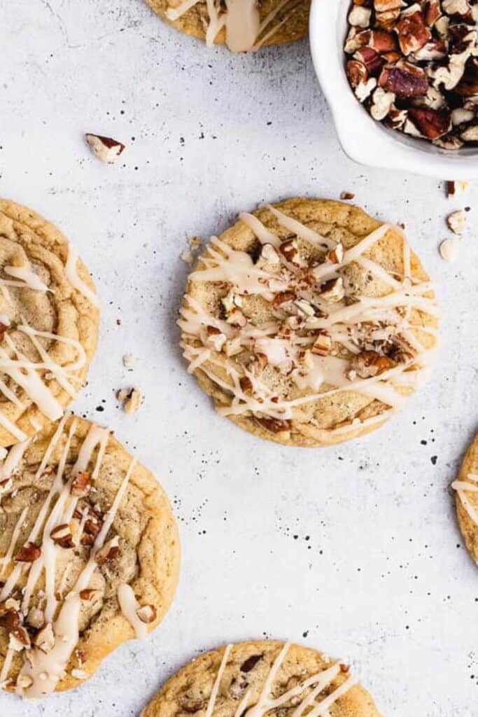 Four fall maple cookies drizzled in icing and pecan pieces. 