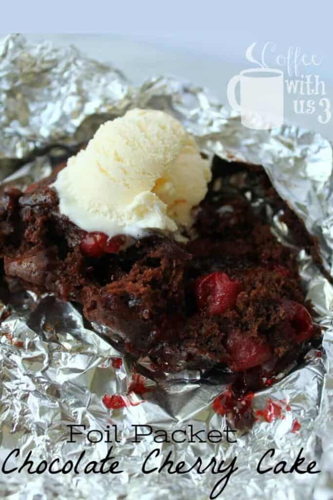 Foil packet chocolate cherry cake with a scoop of vanilla ice cream on top. 