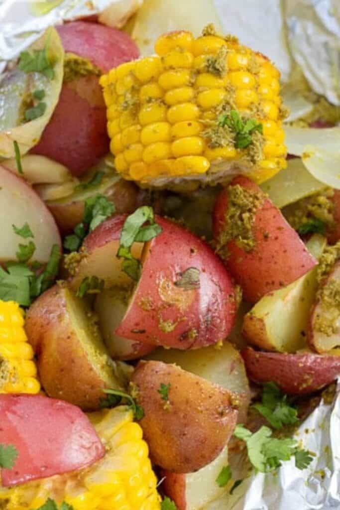 Foil packet baby red potatoes and summer corn on the cob pieces. 