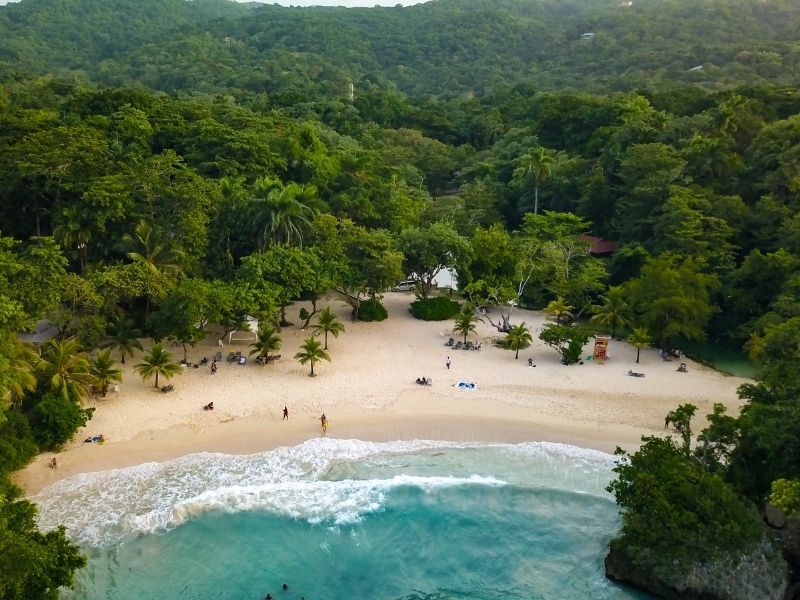 Arial view of Frenchman's Cove, Port Antonio, Jamaica. Tropical forest hills in background.