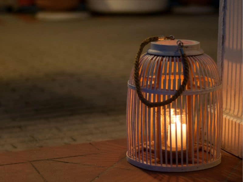 Mtal lantern lit with a candle at night on a ghost tour. 