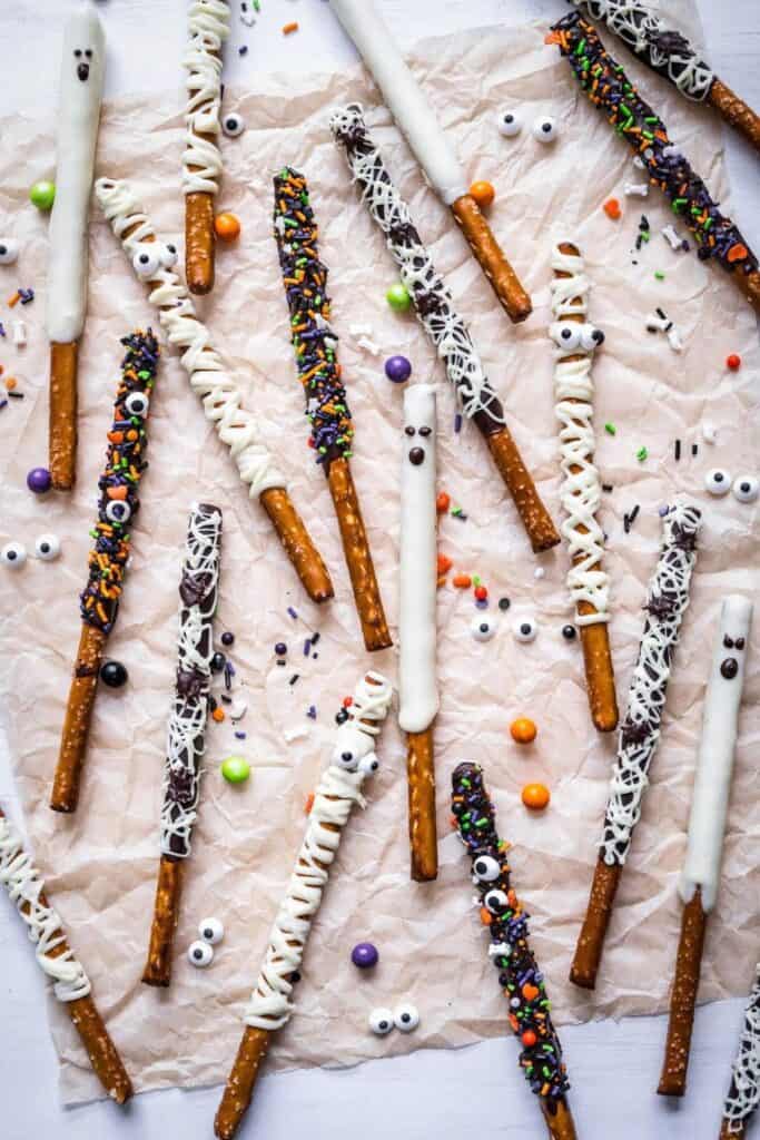 Halloween decorated pretzel sticks with chocolate mummies, and monster eyes.