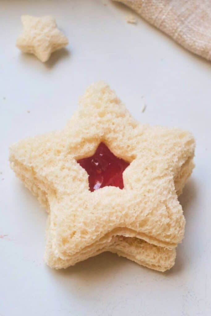 One Christmas Star cut out sandwich with jam showing in the cut out. 