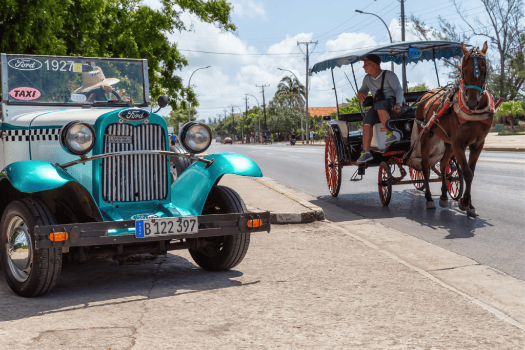 Old Car & Horse Carriage on A road in Varadero Cuba.