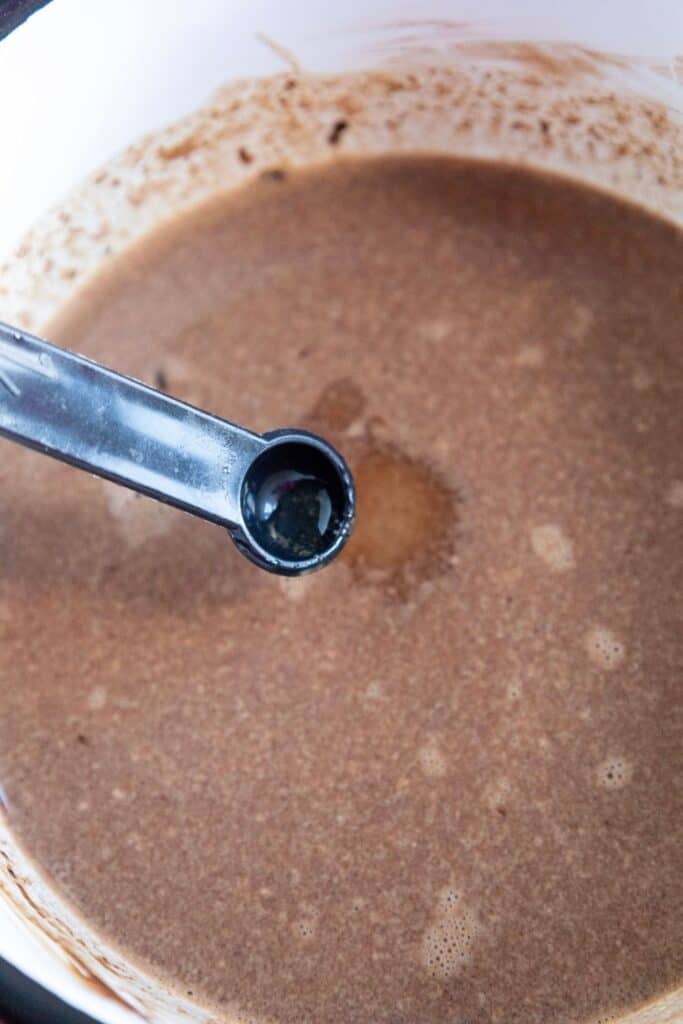 Adding pepperminto oil into hot chocolate.