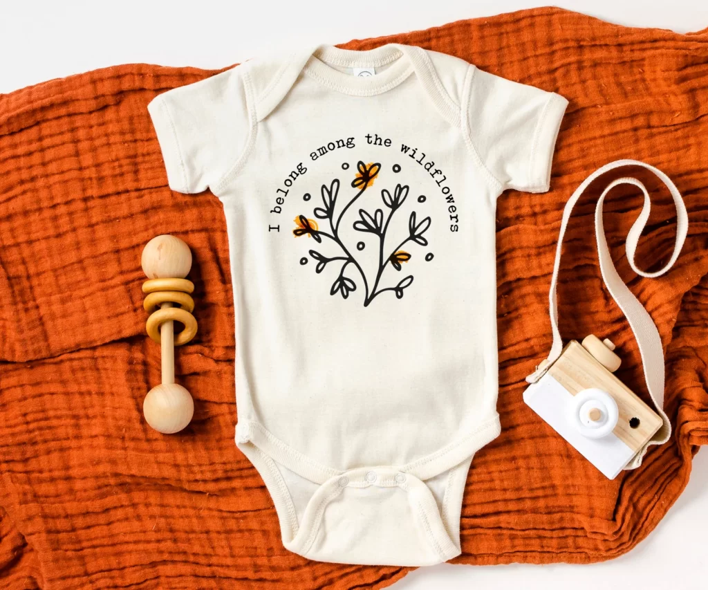 Baby onesie with flowers and saying" I belong among wildflowers ". Eco Gifts for babies