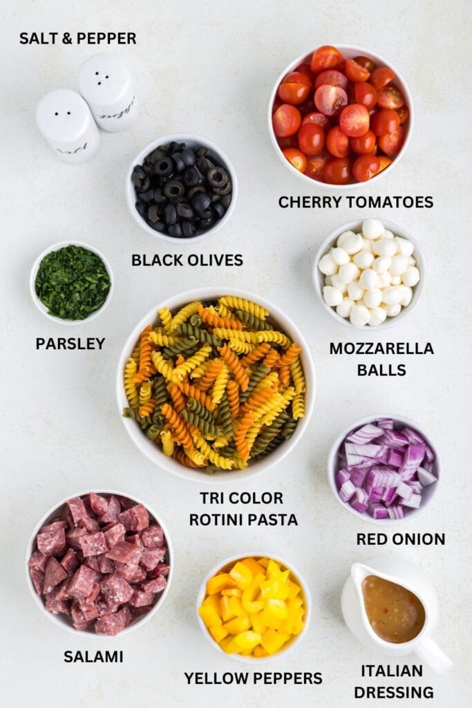 Italian pasta salad ingredients in little bowls.