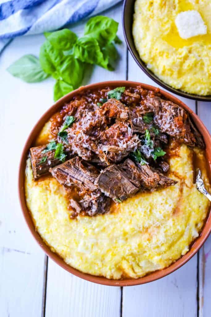 Bowl with half Italian braised beef ragu and half parmesan polenta