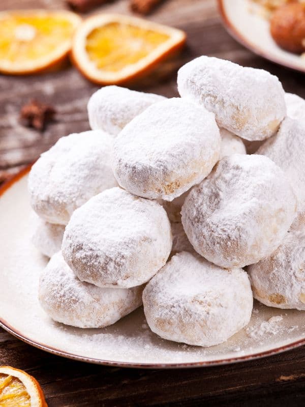 Balls of Greek Koubiades cookies dusted in powdered sugar.