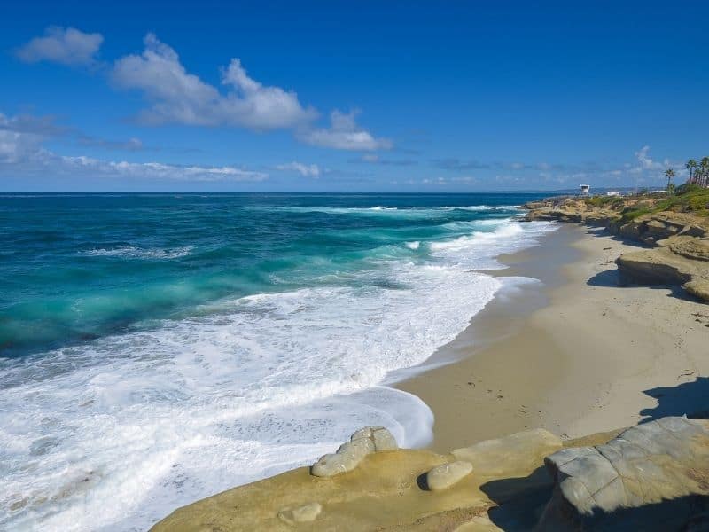 spring break beach vacation ideas for families - La Jolla Beach, San Diego . Rocky shore with clear ocean.